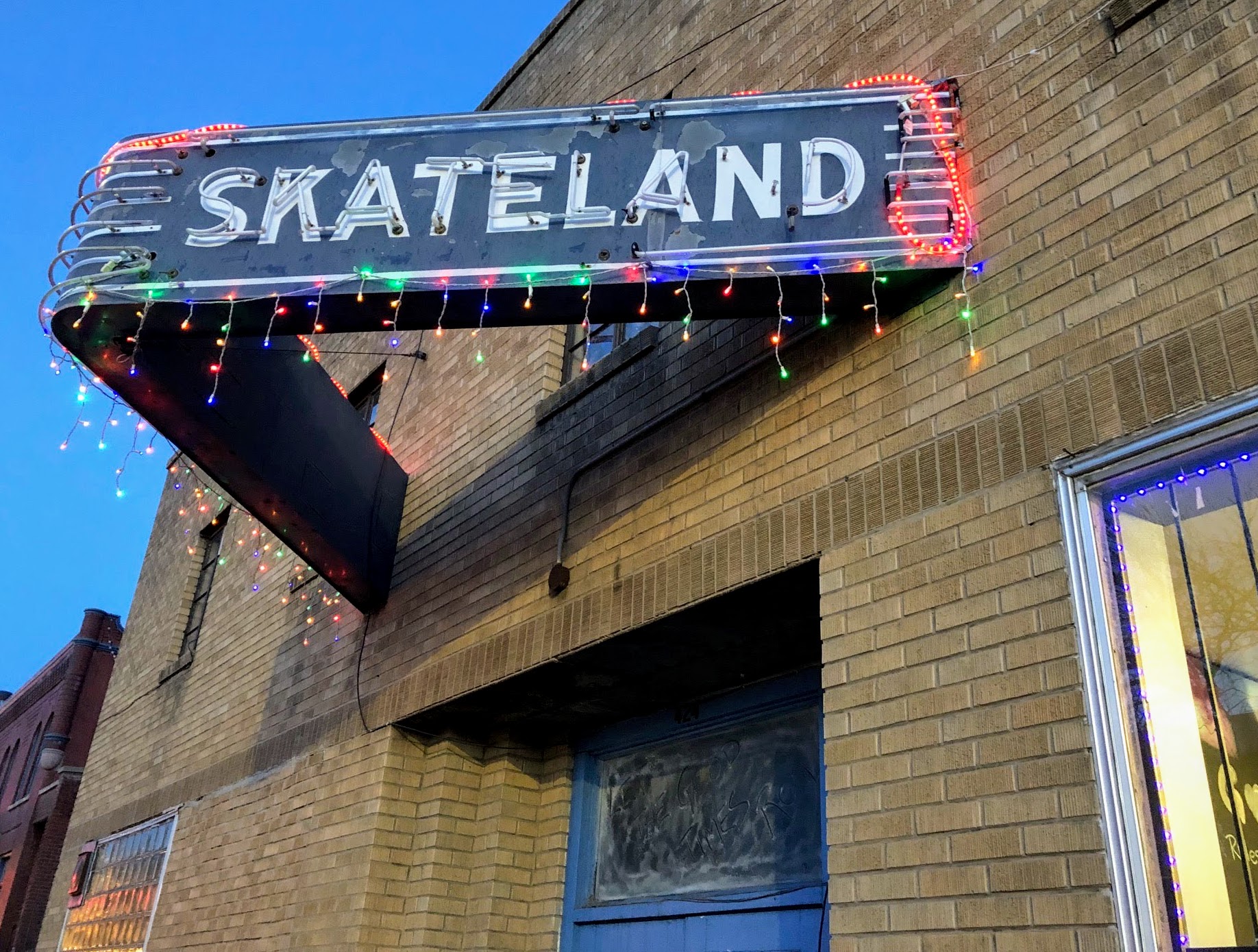 A neon sign reading "Skateland."