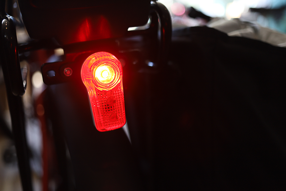 The photo of a red rear bike light.