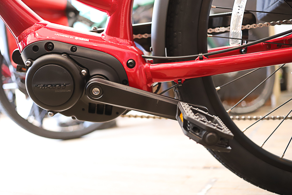 A close up of an eBike's pedals with a mid-drive motor.