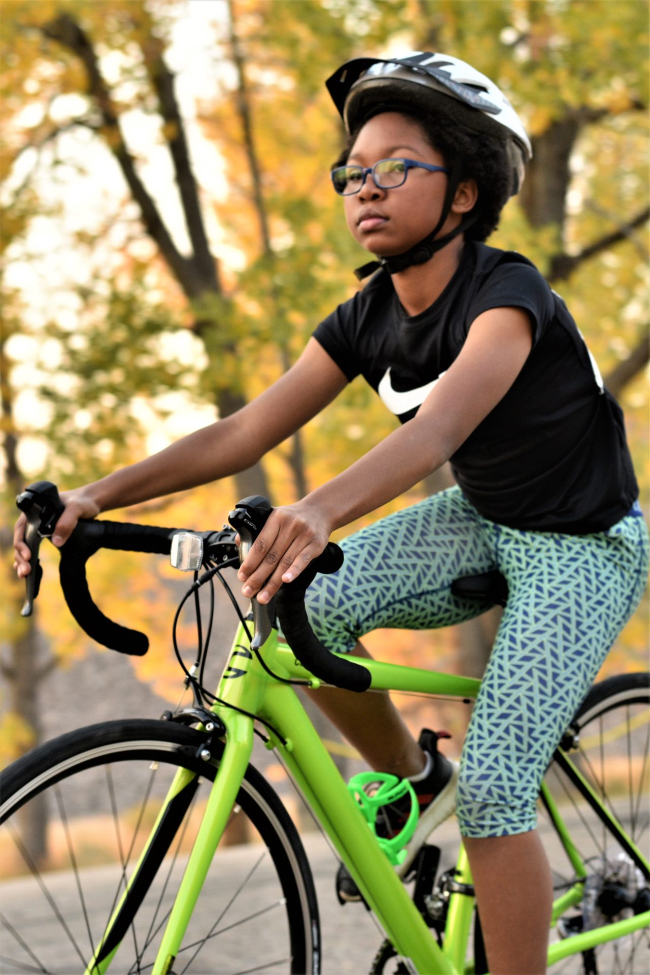 A child rides a bike toward the left of the frame.