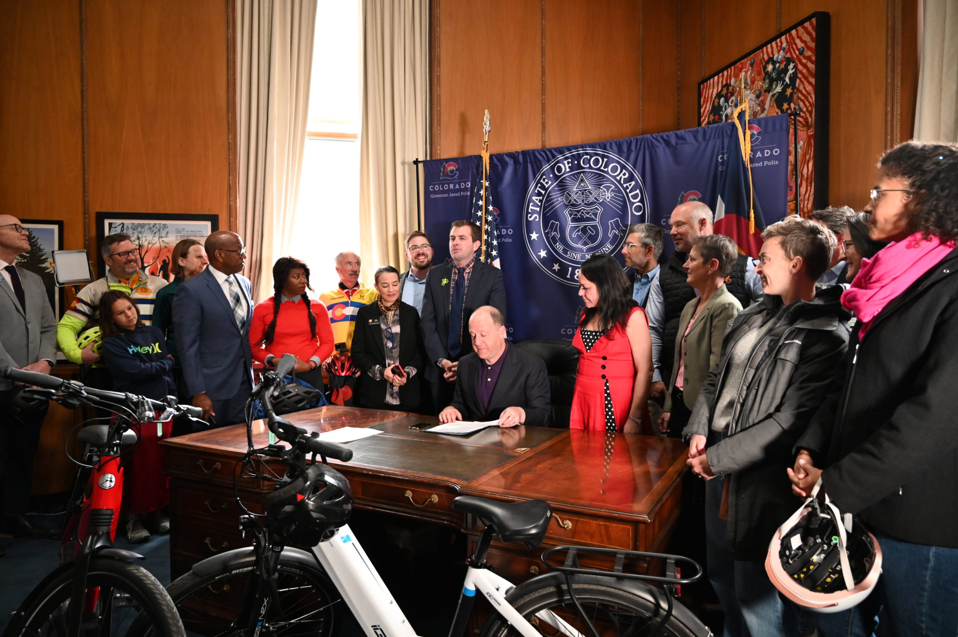 Governor Polis signs a law at the Colorado Capitol