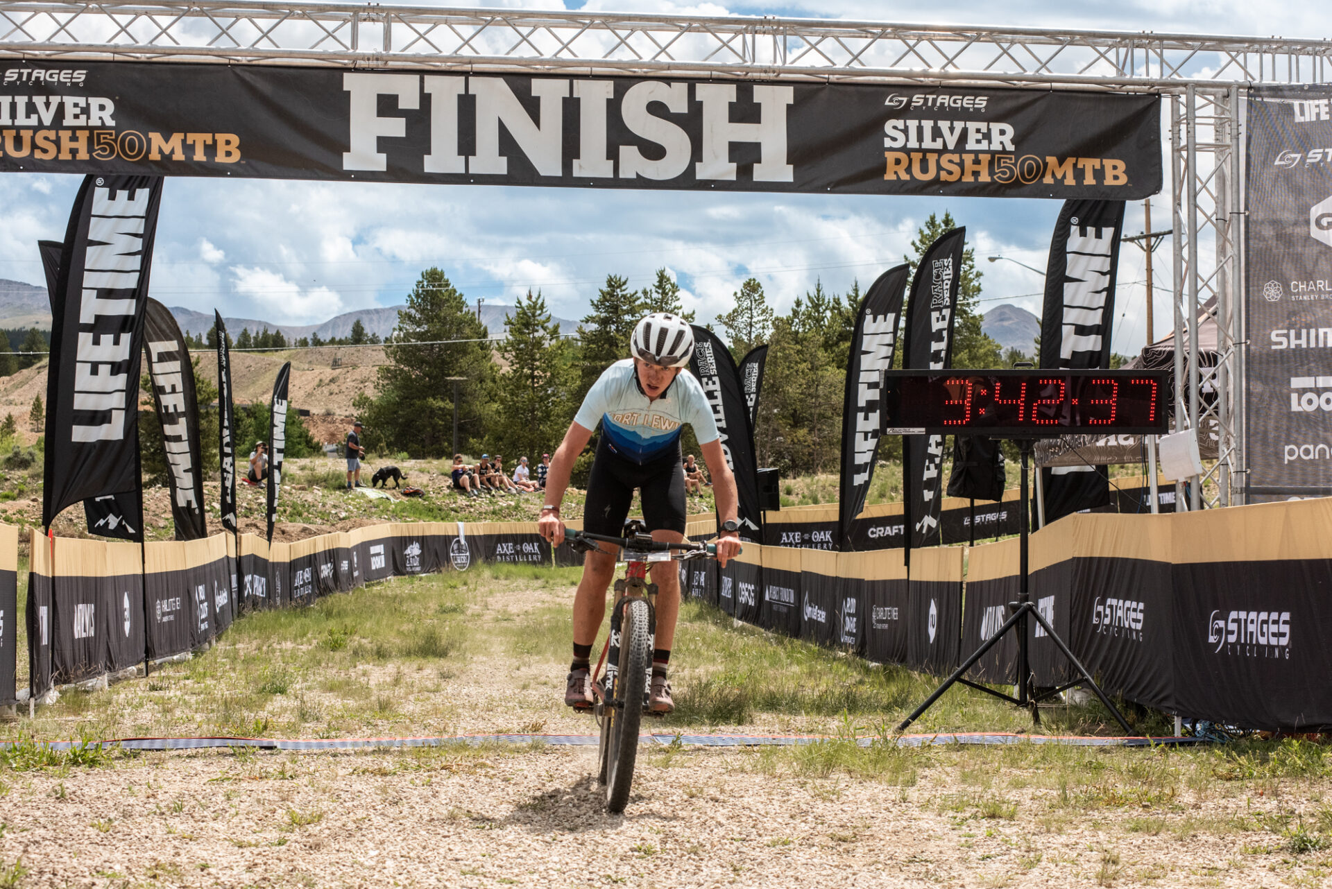 mountain biker riding through finish line